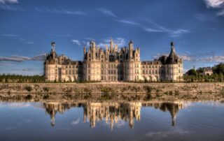 A beautiful shot of the historic Chambord Castle near a reflective lake in France