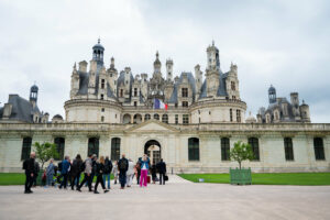 Chambord Castle entrance with people entering to attend the meeting